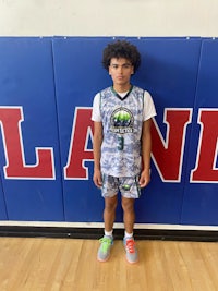 a young man standing in front of a basketball court