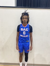 a young man with dreadlocks posing for a photo