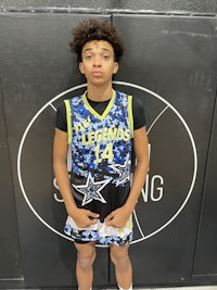 a young boy is posing for a photo in a basketball uniform