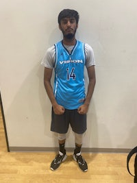 a man in a basketball uniform standing in front of a wall