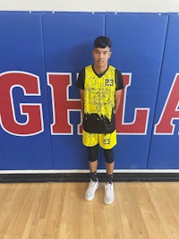 a young man standing in front of a basketball court