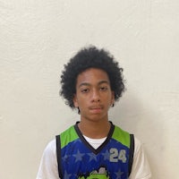 a young man in a basketball uniform posing for a picture