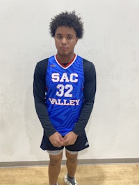 a young man in a basketball uniform posing for a photo
