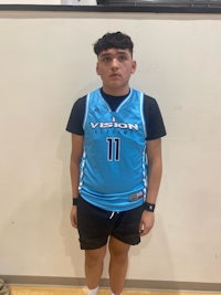 a young man in a basketball uniform standing in front of a wall