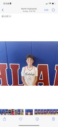 a picture of a boy posing in front of a basketball court