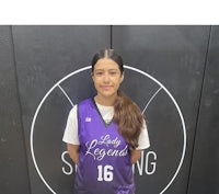 a young girl wearing a purple and black basketball jersey